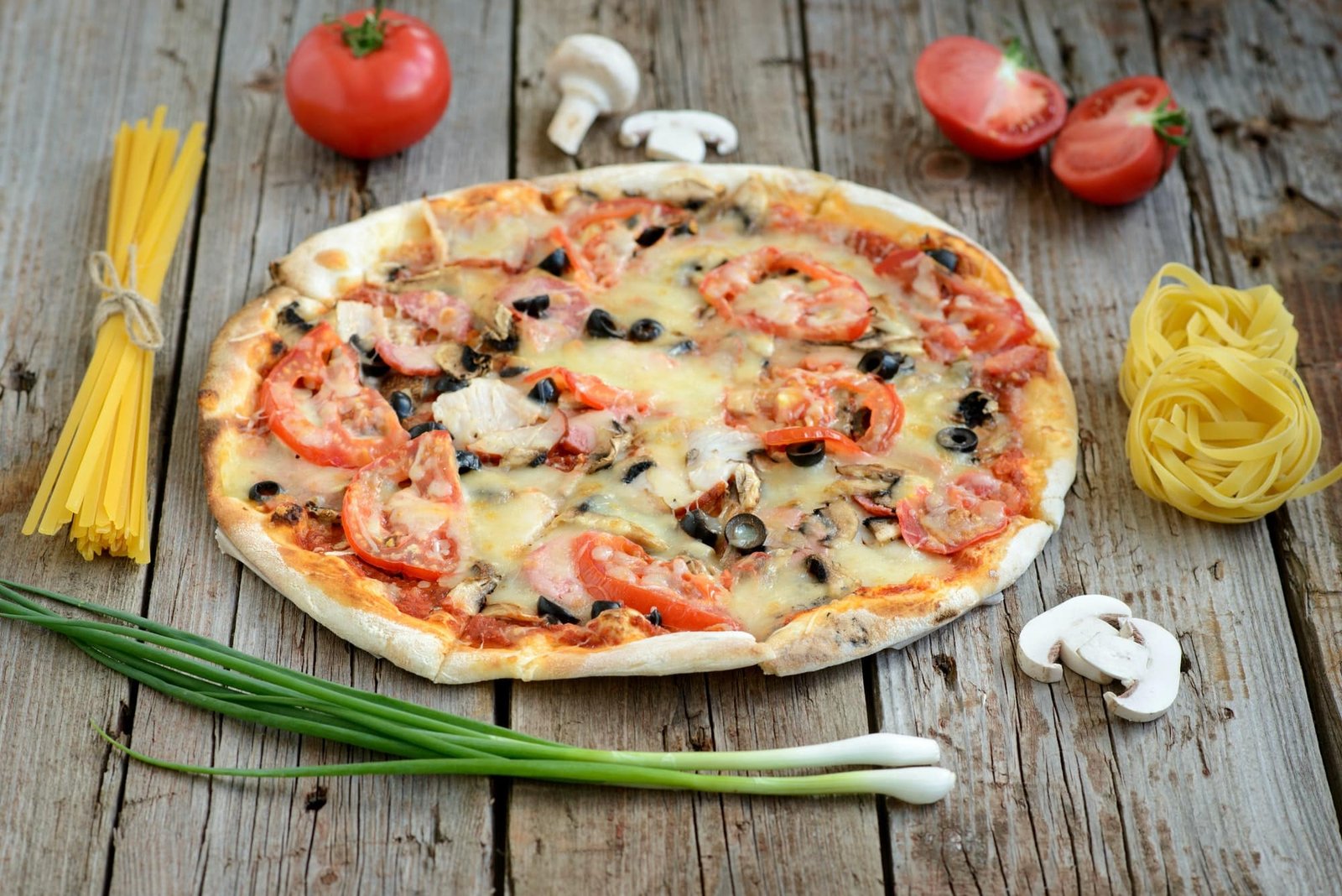 Healthy, gluten free cauliflower crust pizza with tomatoes