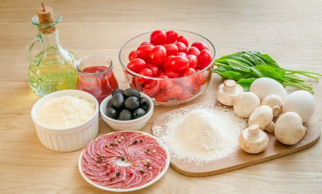 Ingredients for pizza on the wooden background
